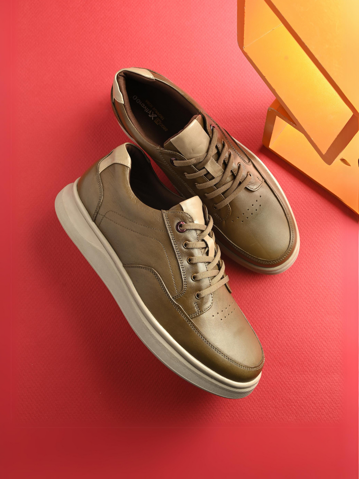 Brown sneakers on a red background