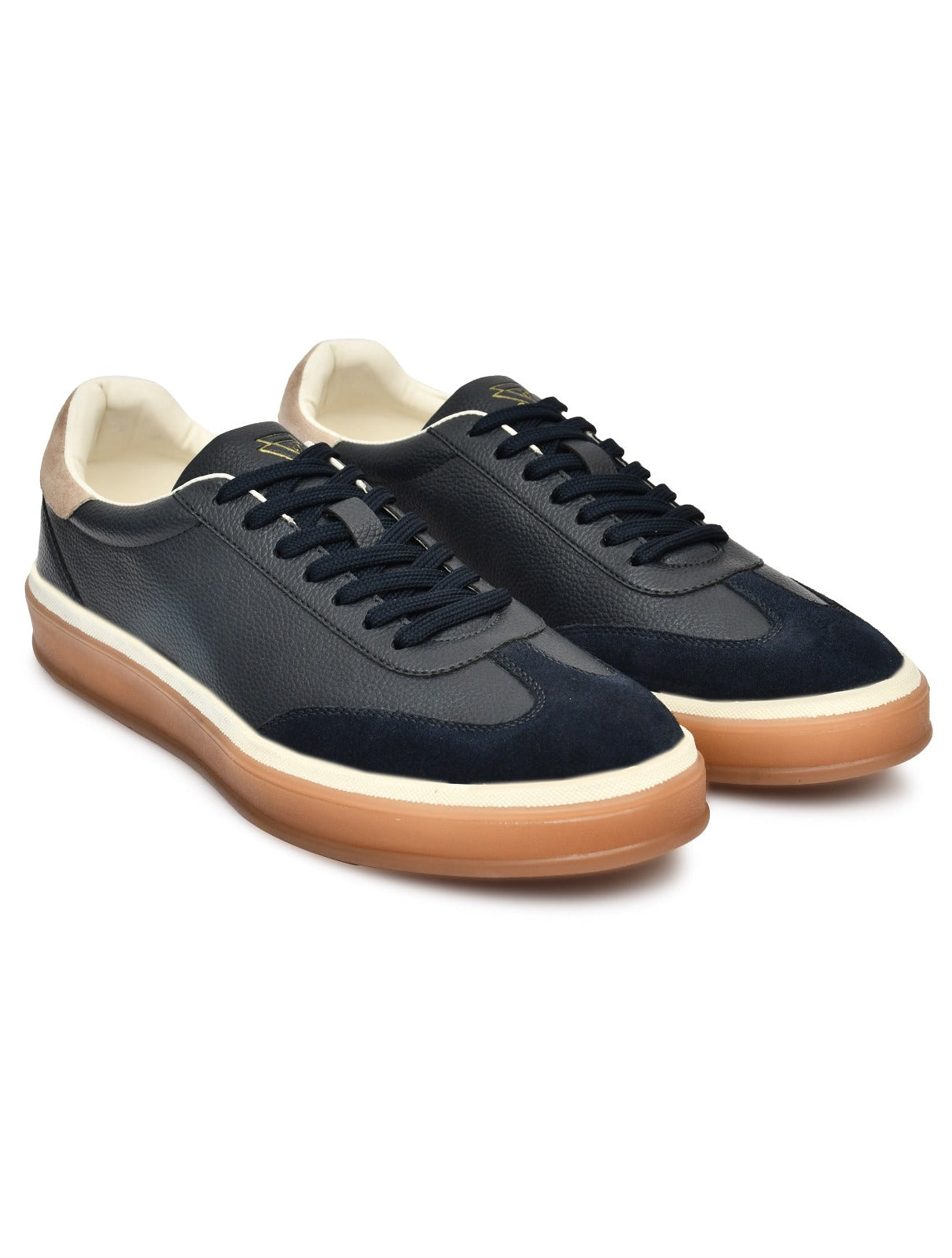 Pair of navy blue sneakers with brown soles on a white background