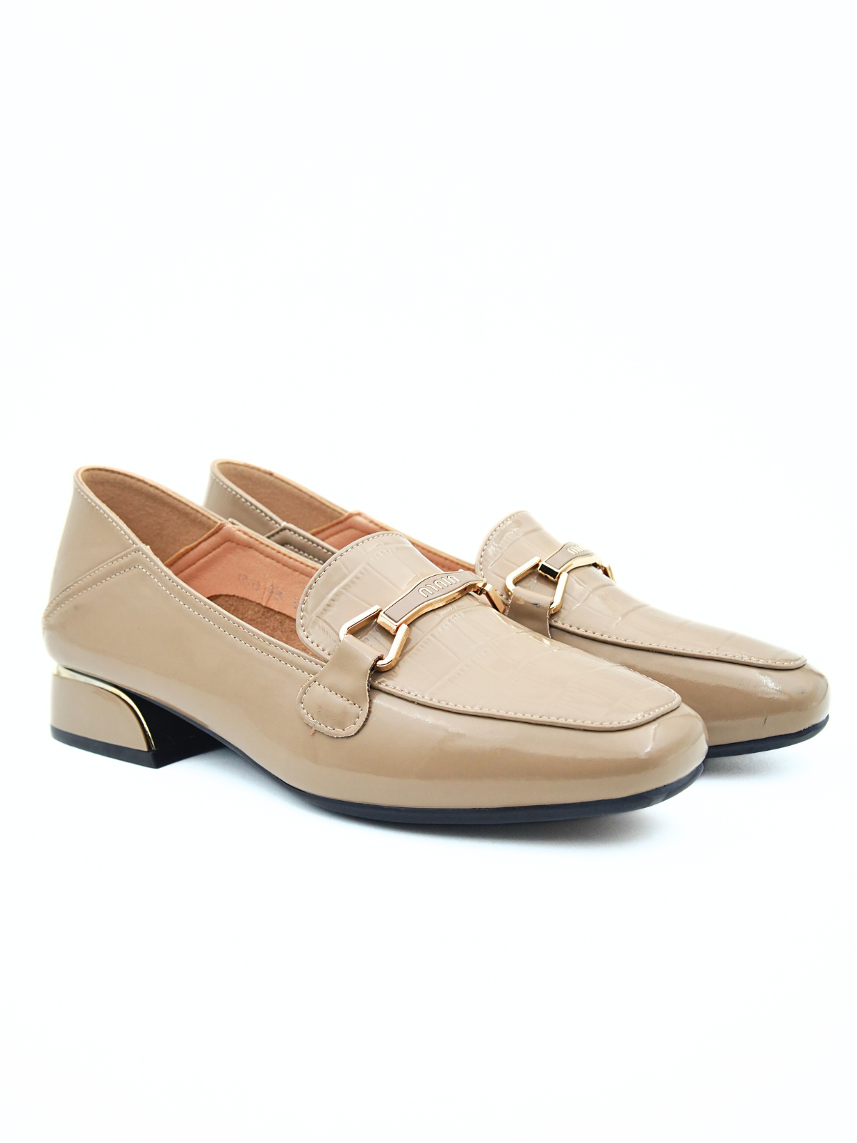 Pair of beige loafers with gold accents on a white background