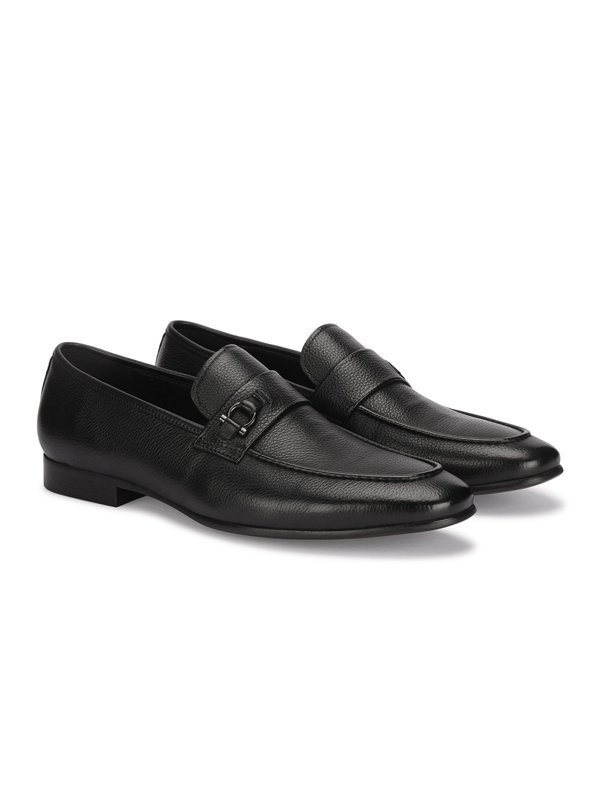 Pair of black leather loafers on a white background