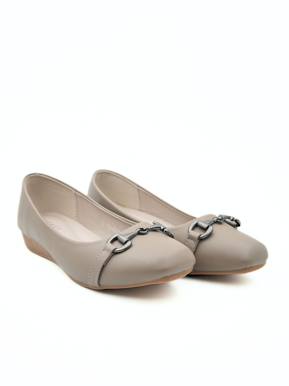Pair of beige flat shoes with a decorative metal chain on a white background