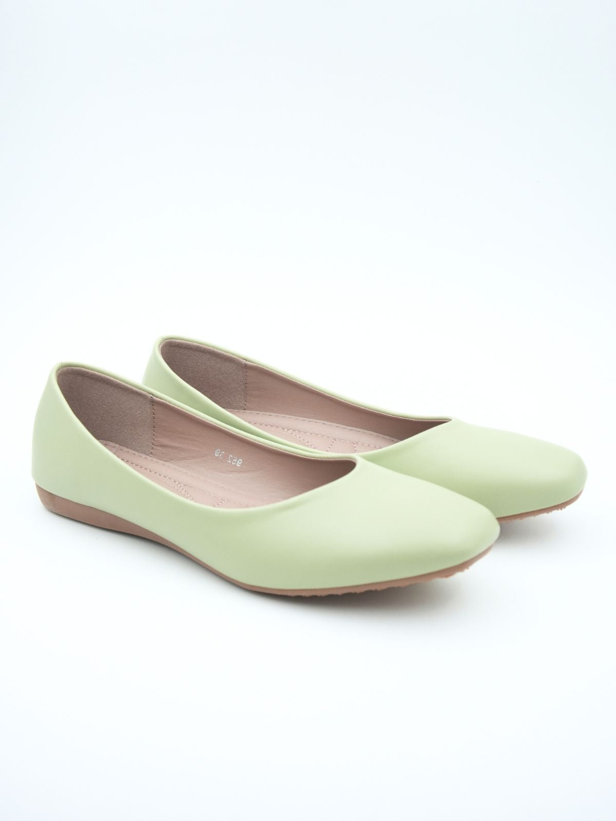 Pair of light green flat shoes on a white background