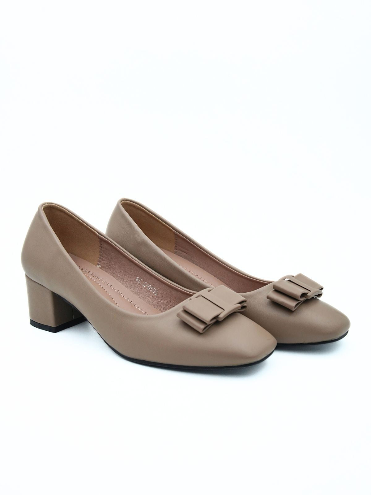 Pair of beige shoes with bow details on a white background