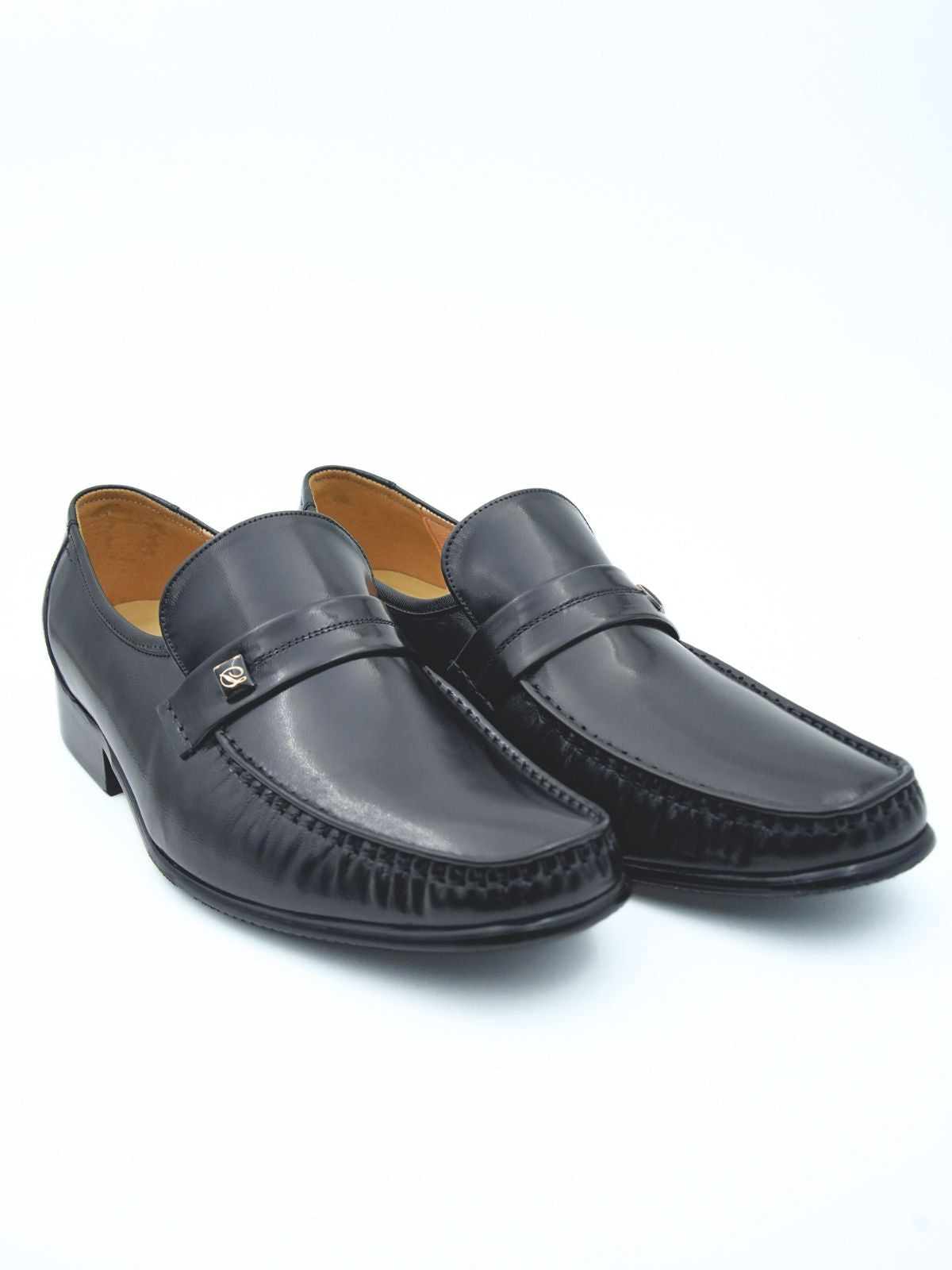 Pair of black loafers on a white background