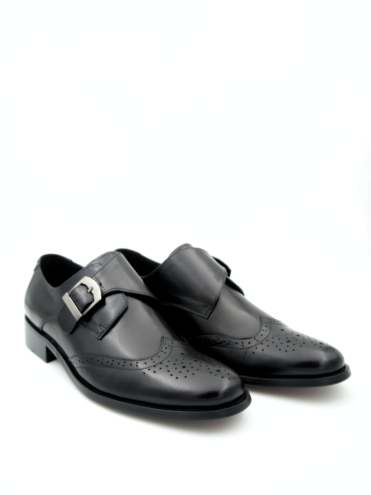 Pair of black dress shoes with buckles on a white background