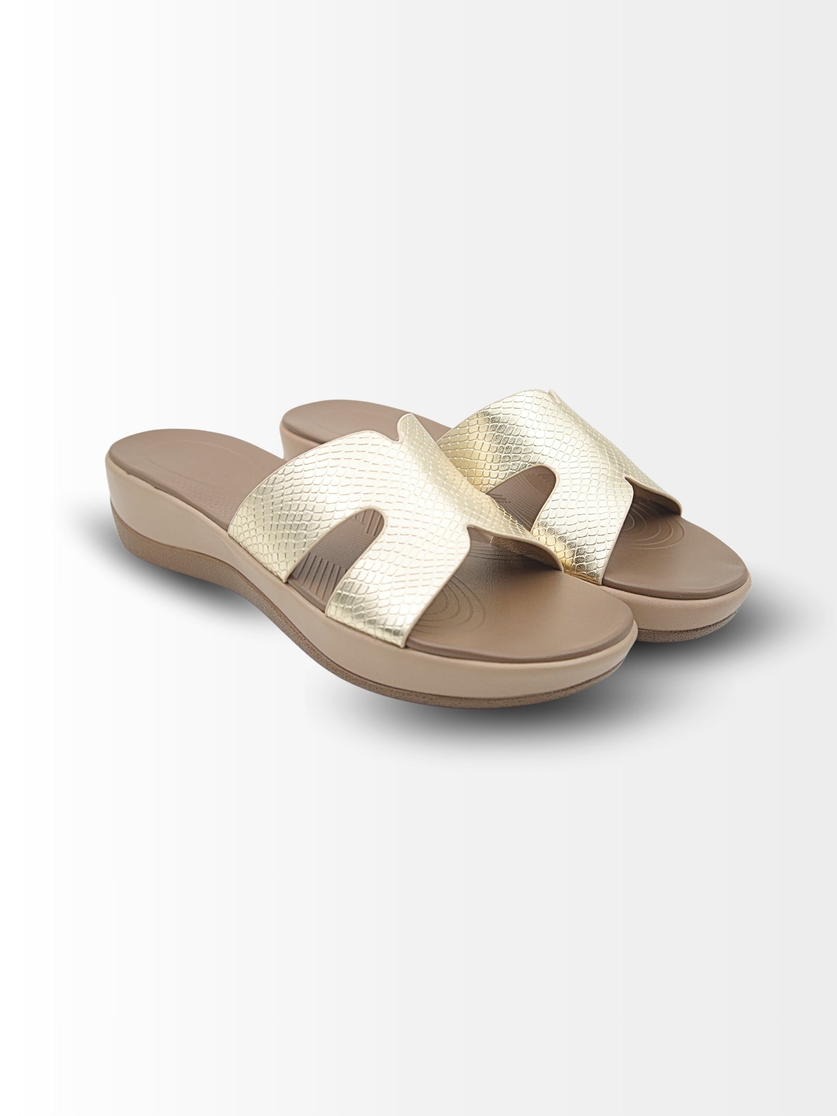 Pair of gold and beige sandals on a white background