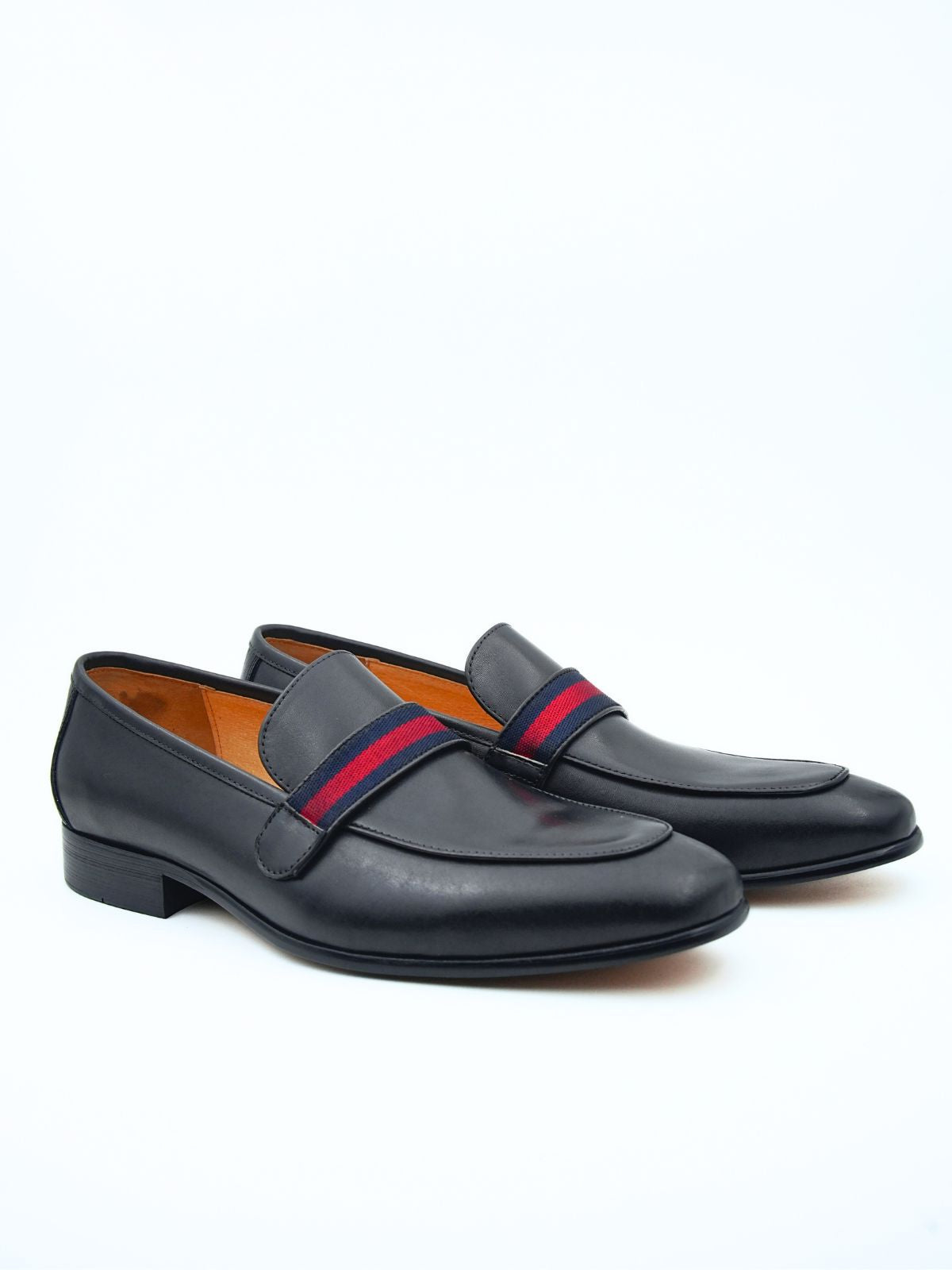 Pair of black loafers with red and blue striped straps on a white background