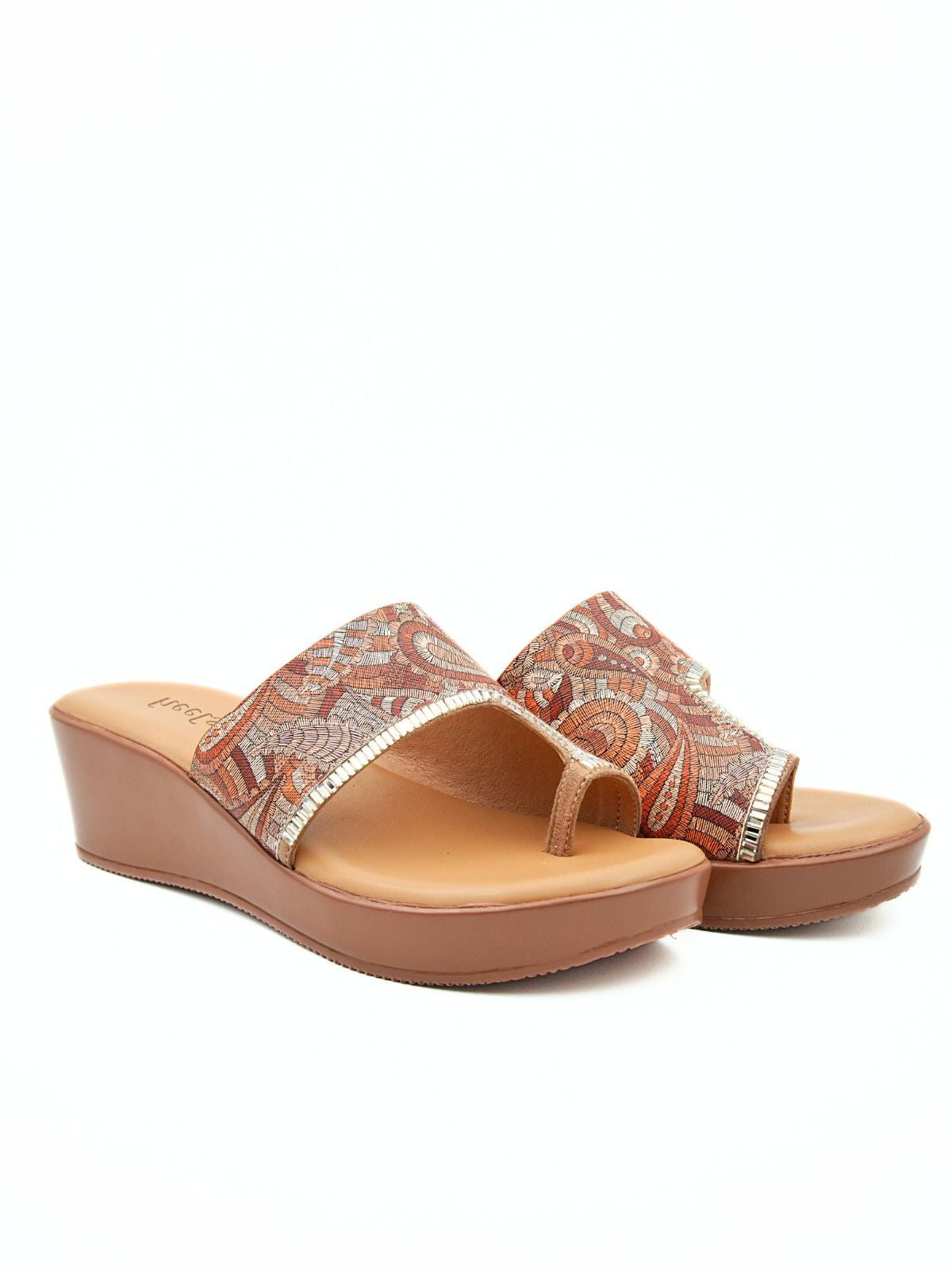 Pair of wedge sandals with patterned straps on a white background