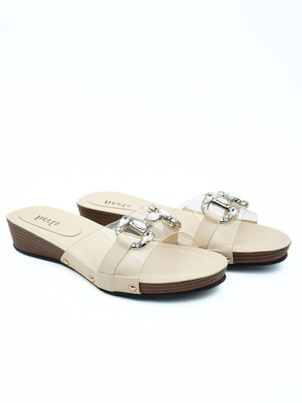 Pair of beige sandals with silver buckles on a white background