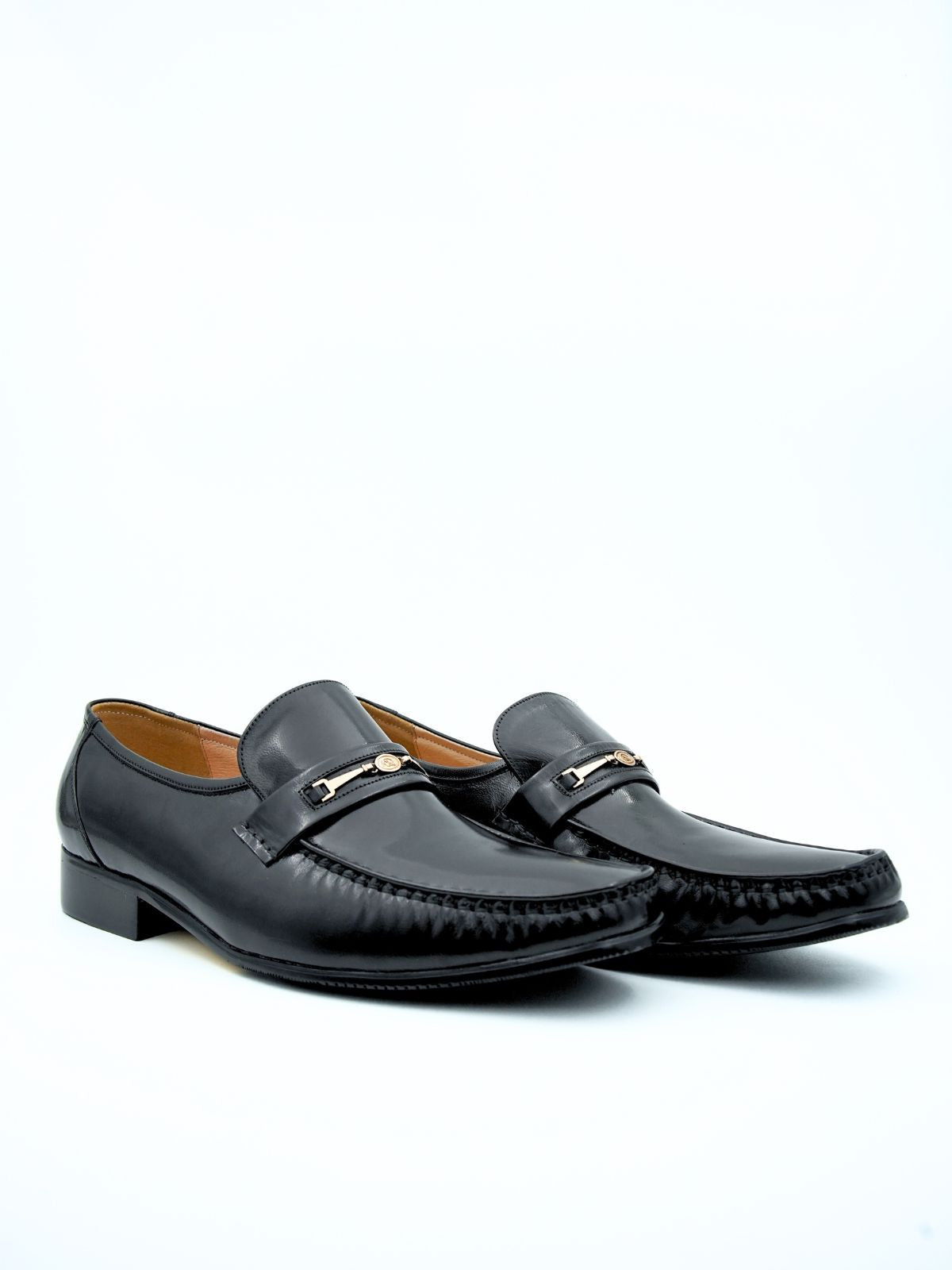 Pair of black loafers on a white background
