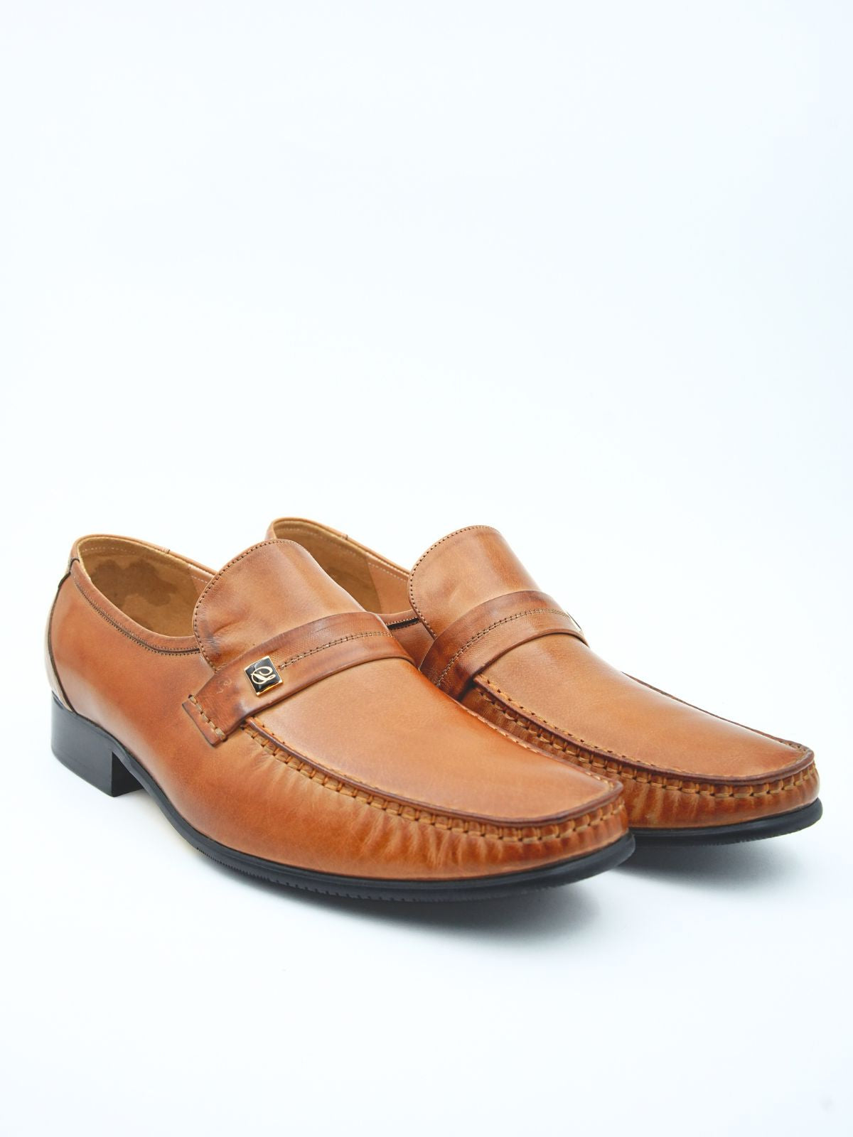 Pair of brown leather loafers on a white background