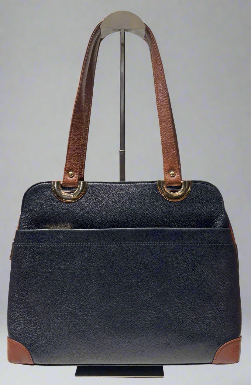 Navy handbag with brown handles and accents on a white background